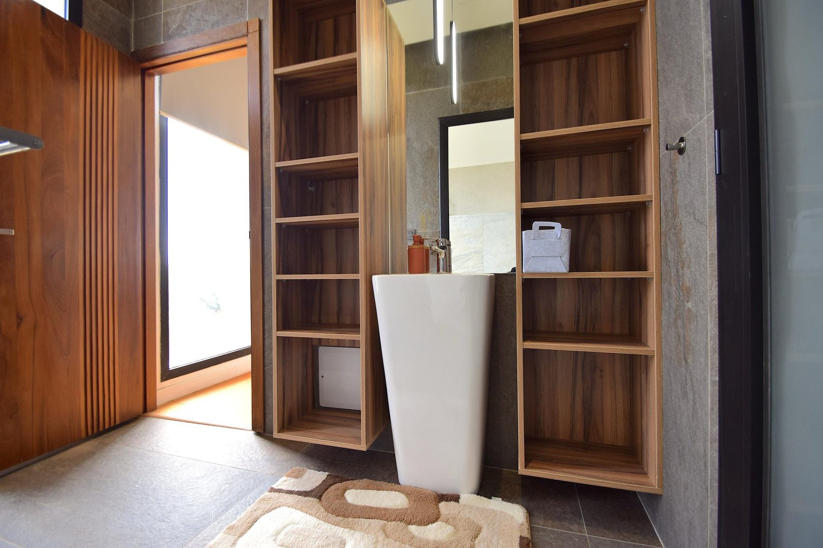 Salle de bain avec vasque colonne et rangements en bois